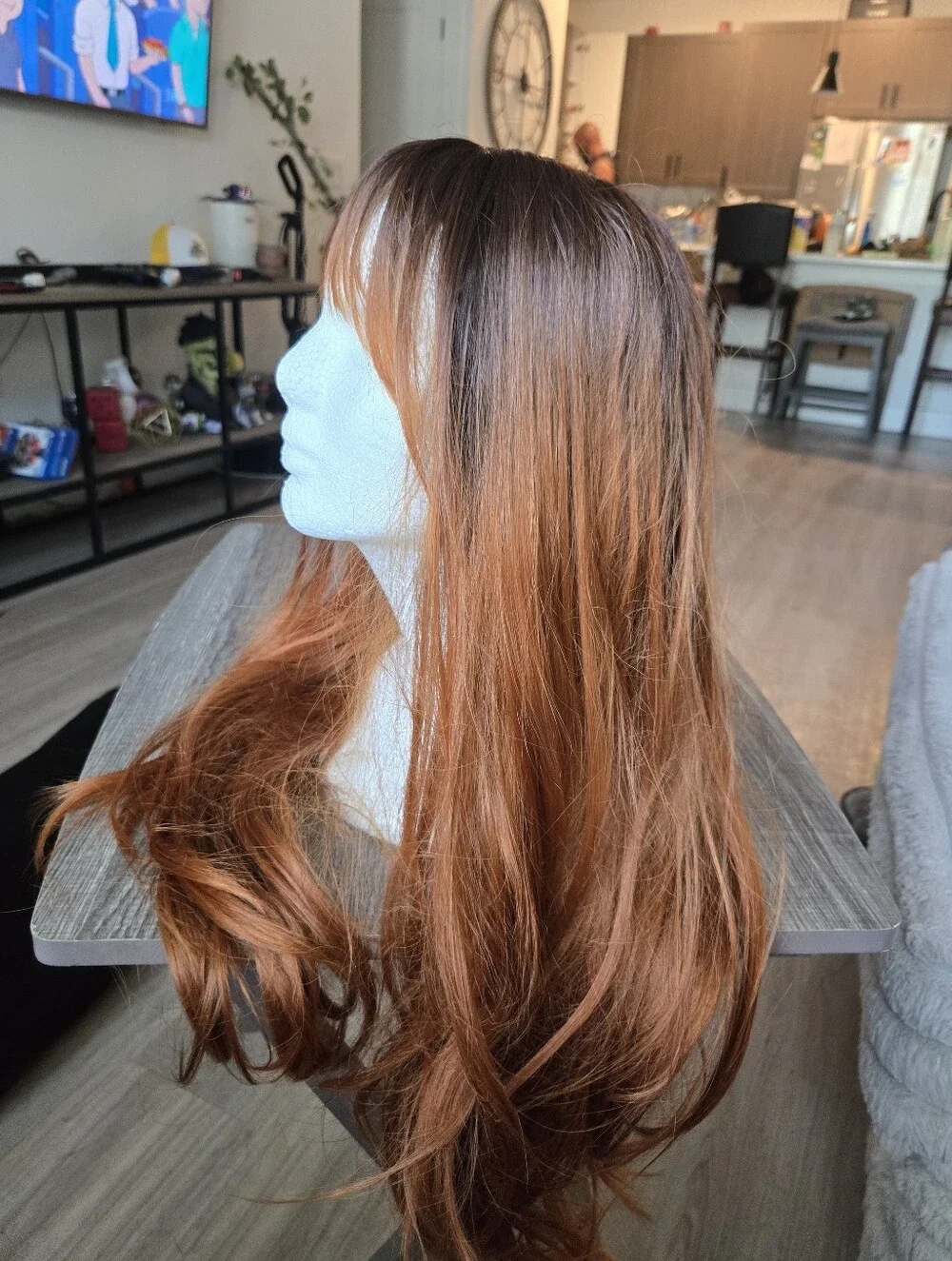 long auburn wig with dark brown roots and face-framing wispy bangs Sunthetic